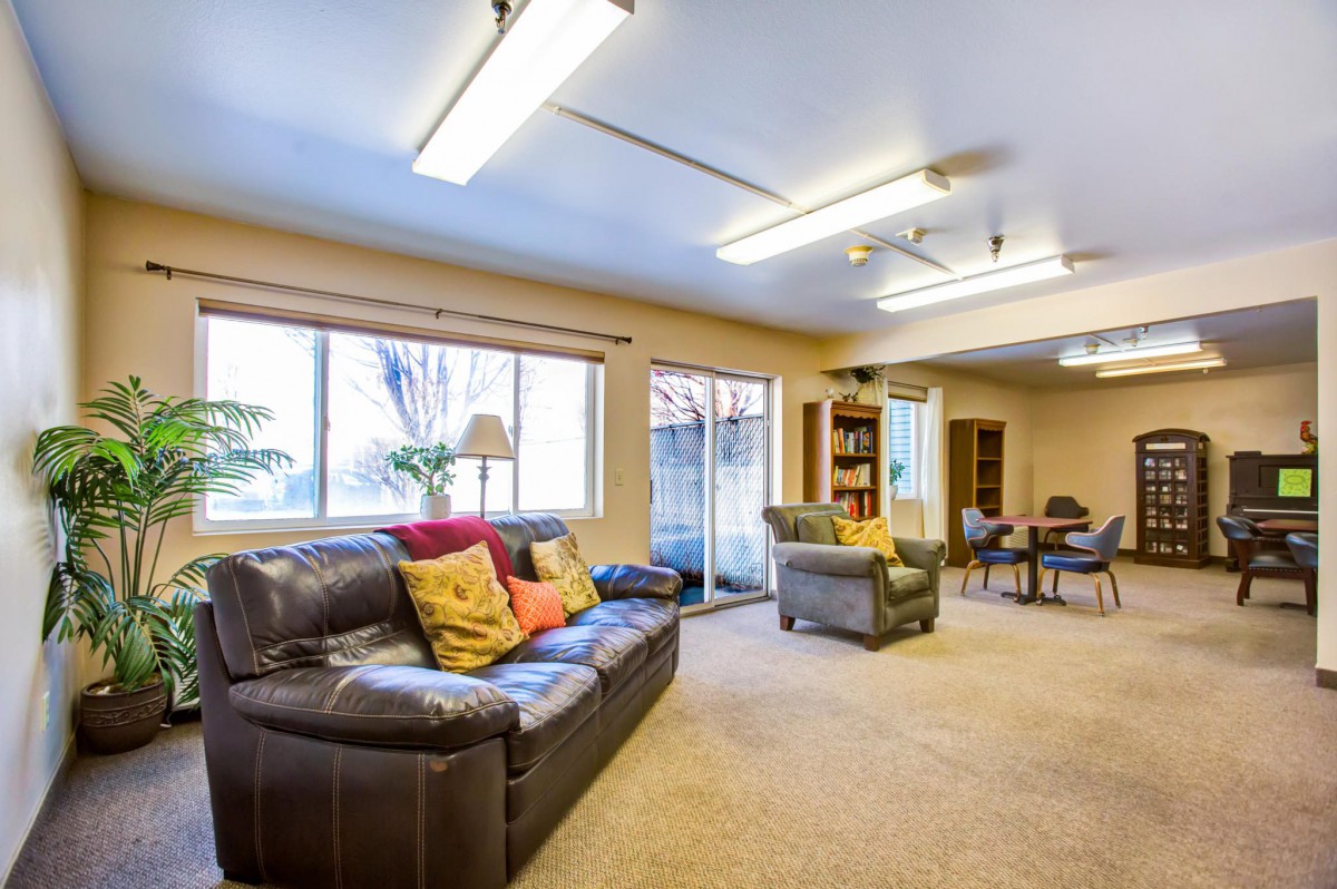 A spacious living room with comfortable seating and ample natural light.