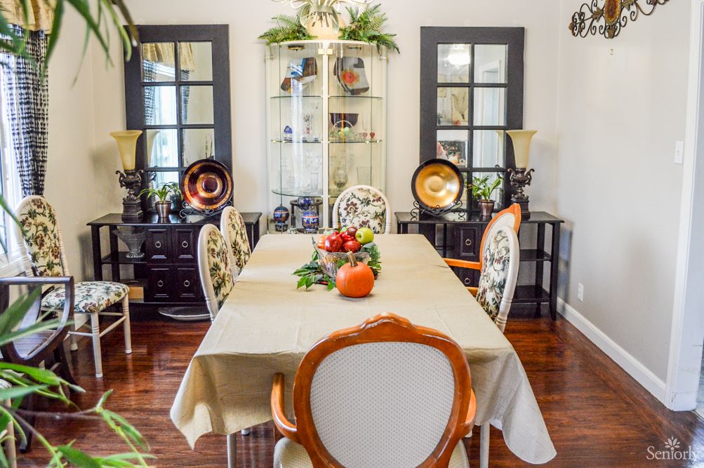 An elegant dining room with a beautifully set table and stylish chairs.