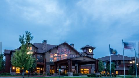 A scenic view of a large hotel or resort building during the evening.