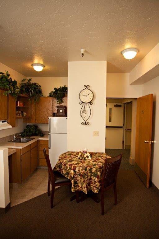 A cozy kitchen and dining area with a small table and decorative elements.