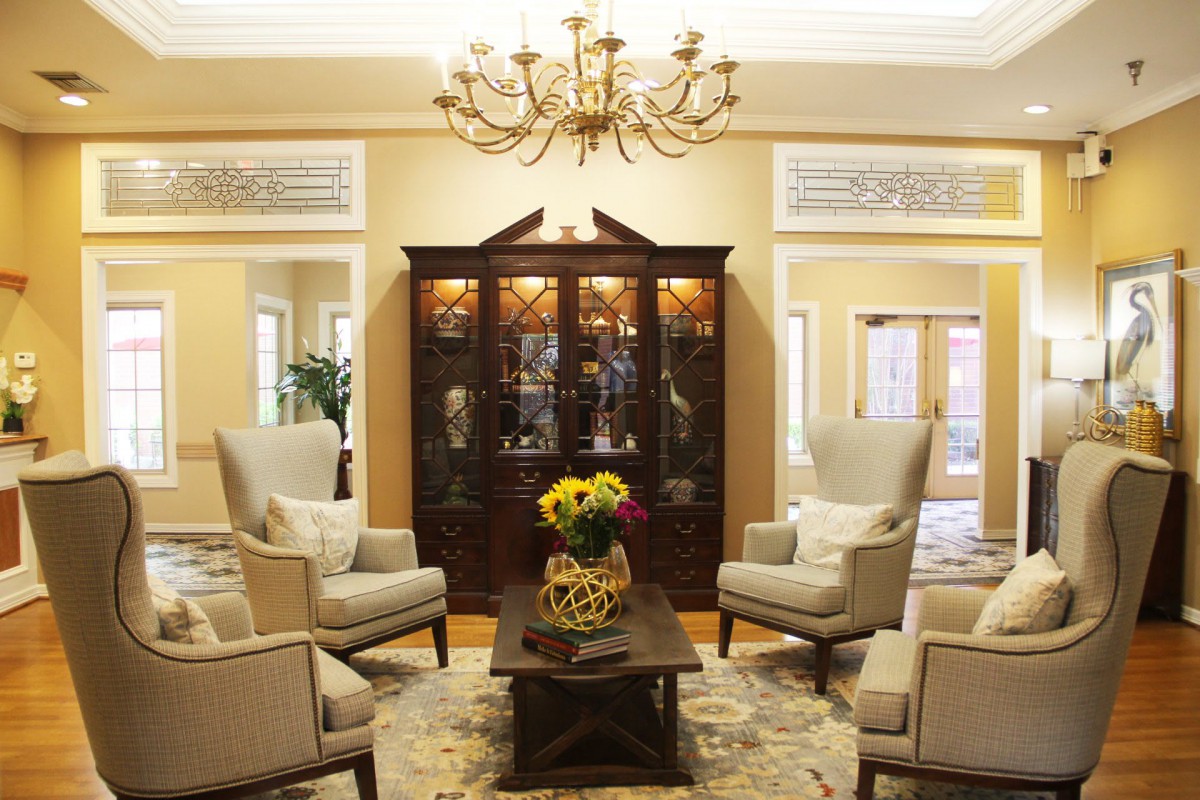 Elegant living room with armchairs and a chandelier.
