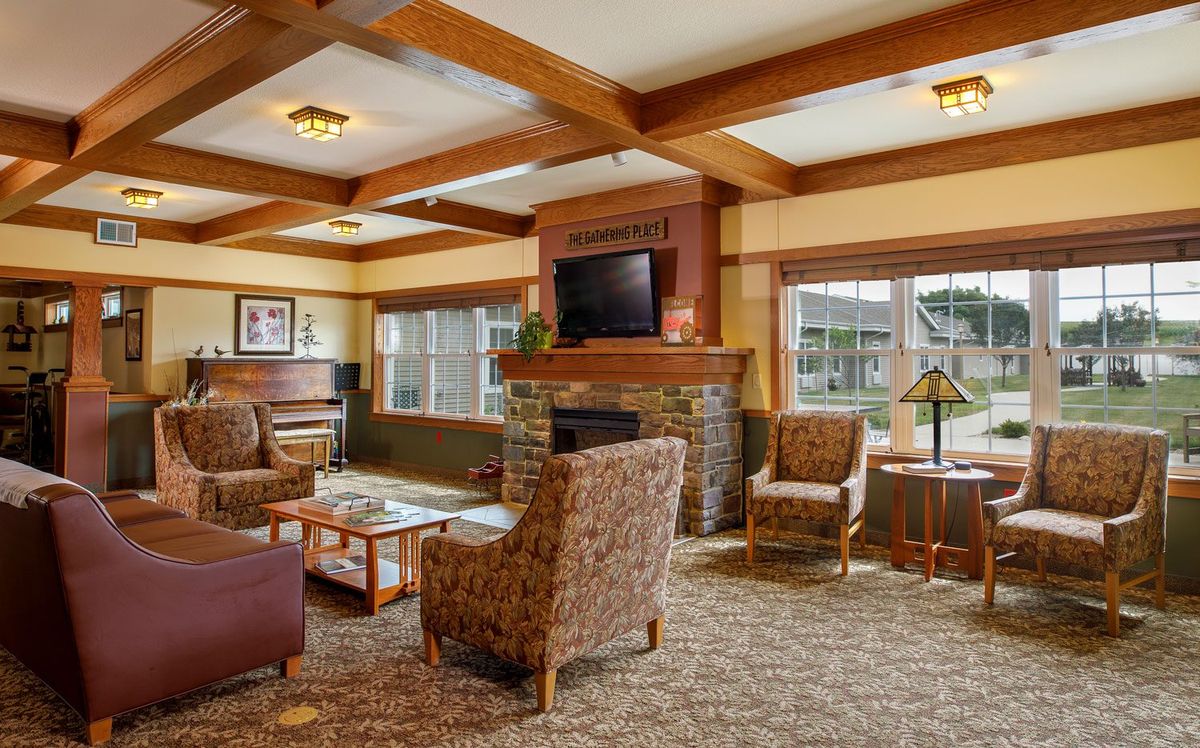Cozy living room with a fireplace, TV, and comfortable seating.