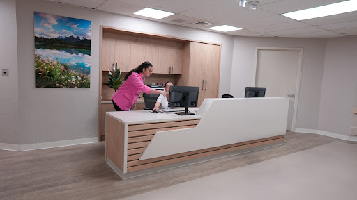 A receptionist preparing at a modern office desk.