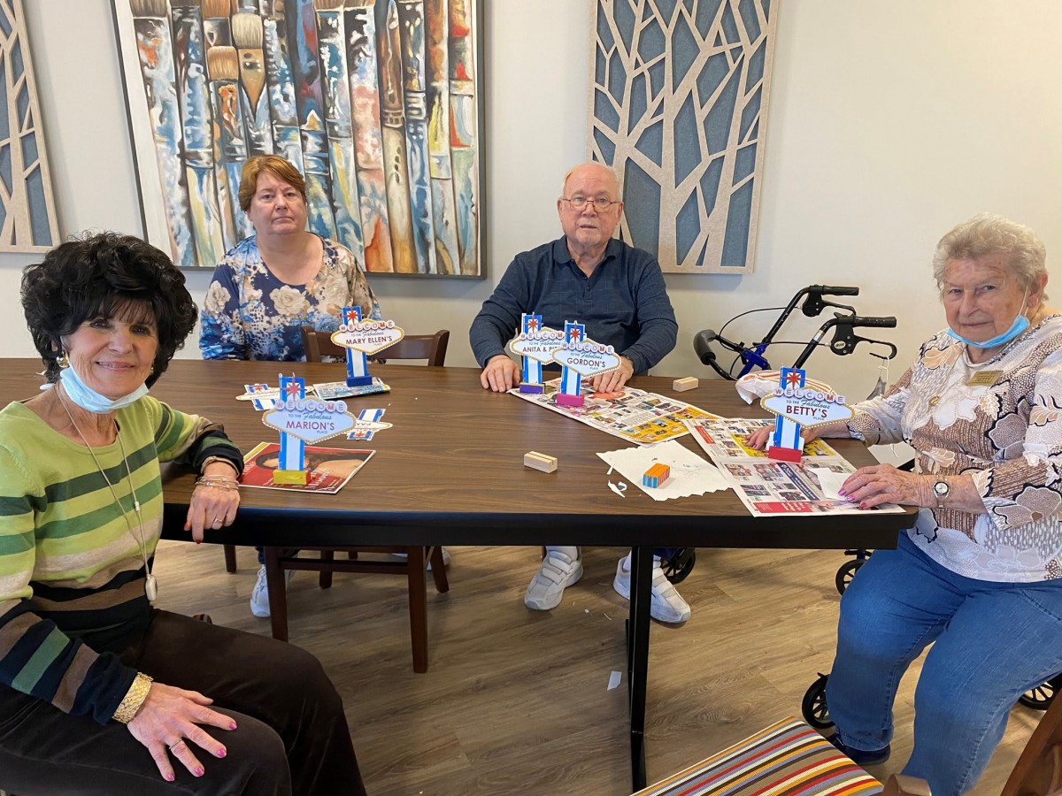 Group of seniors engaging in a creative activity around a table.
