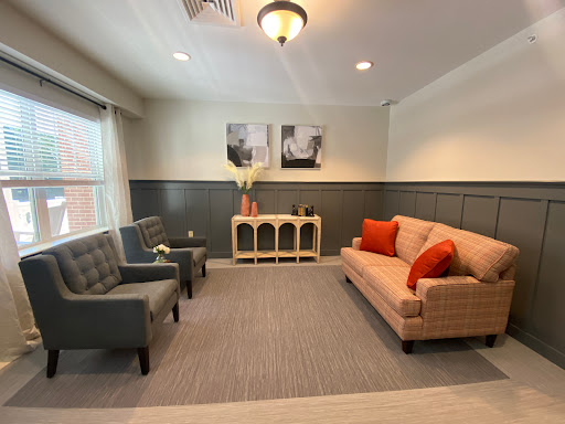 A cozy and modern living room space featuring a comfortable sofa and stylish chairs.