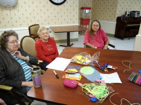 Seniors enjoying a creative activity at a community center.