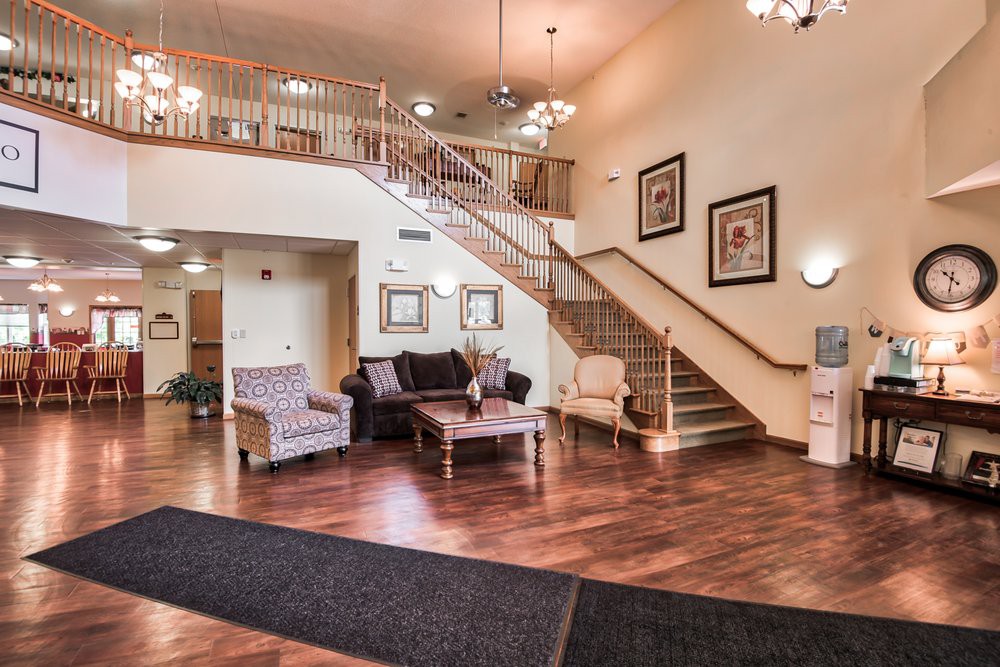 A spacious hotel lobby with elegant seating and a staircase.