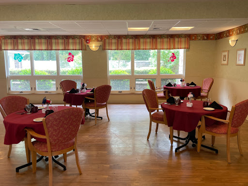 A warm and inviting dining area with red tablecloths and festive decorations.