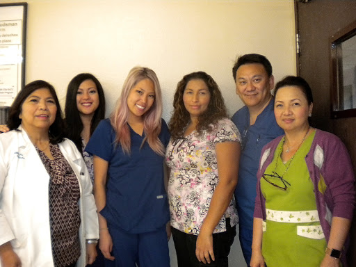 A group of healthcare professionals posing together in a friendly setting.