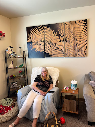 A person relaxing in a cozy living room with modern decor and artwork.