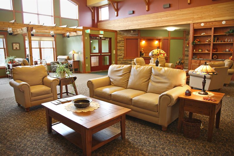 A cozy and spacious living room with comfortable seating and warm lighting.