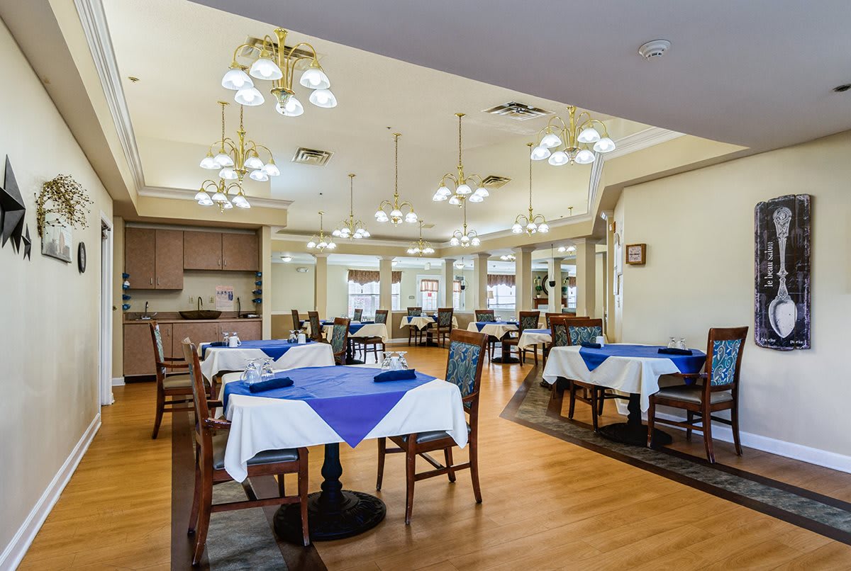 A cozy dining area with neatly set tables and ambient lighting.