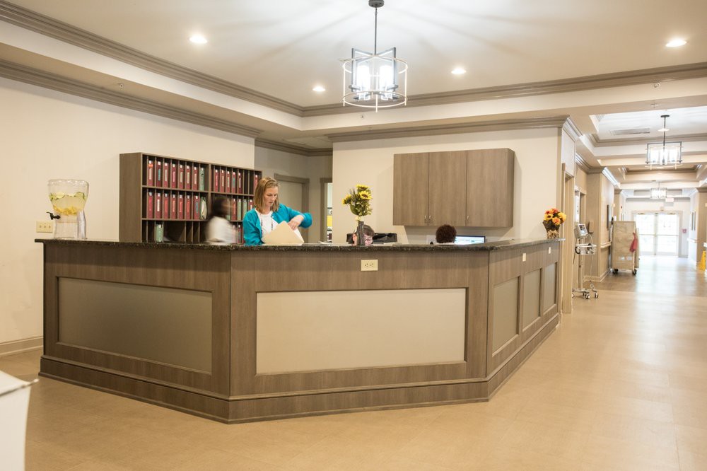 A well-lit reception area with staff attending to paperwork.