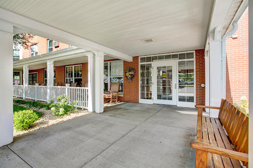 A welcoming entrance to a home with comfortable seating and a spacious porch.