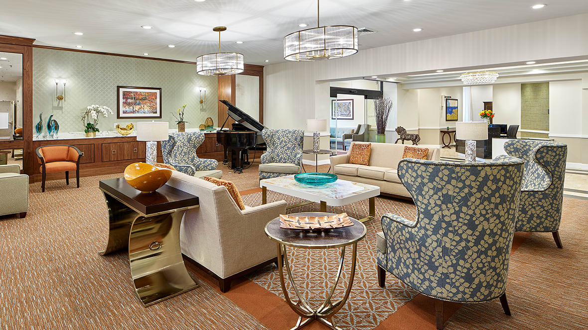 A stylish and modern living room with elegant furniture and a grand piano.