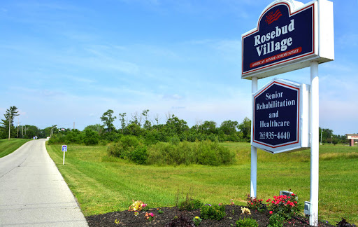 Entrance to Rosebud Village, a senior rehabilitation and healthcare facility surrounded by lush greenery.