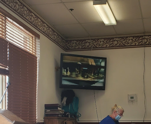 A cozy waiting area featuring a television displaying scenic imagery.