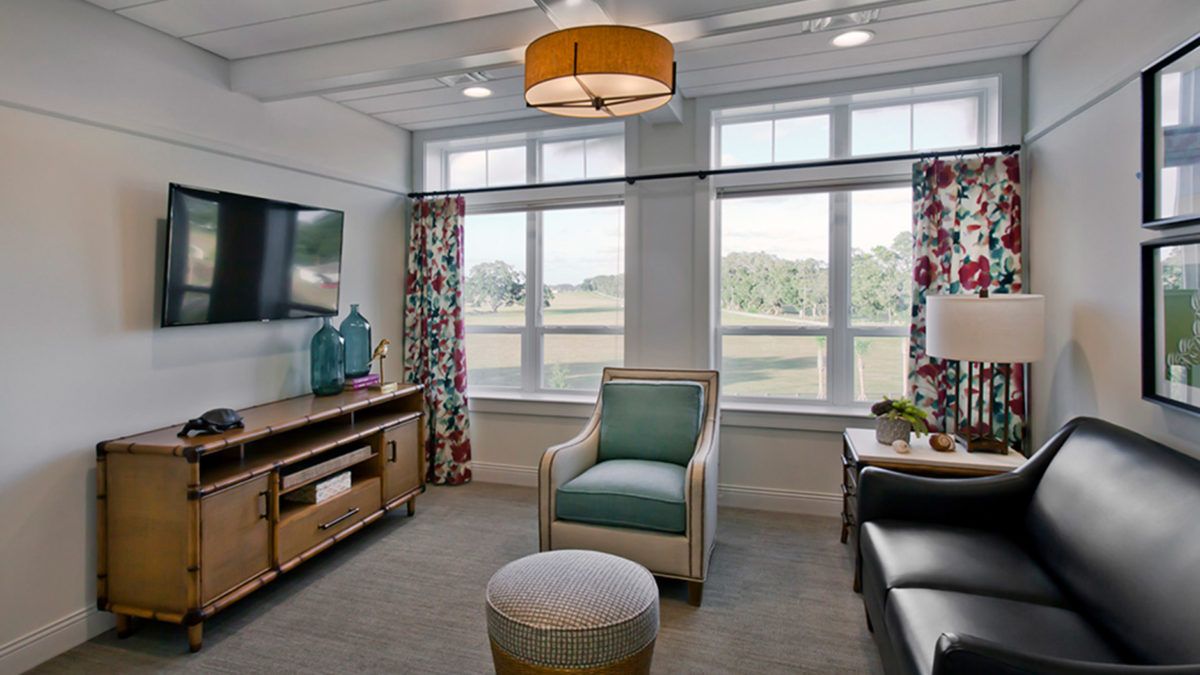 A well-lit living room with comfortable seating and modern decor.