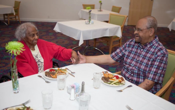 Two people enjoying a meal together in a dining setting.