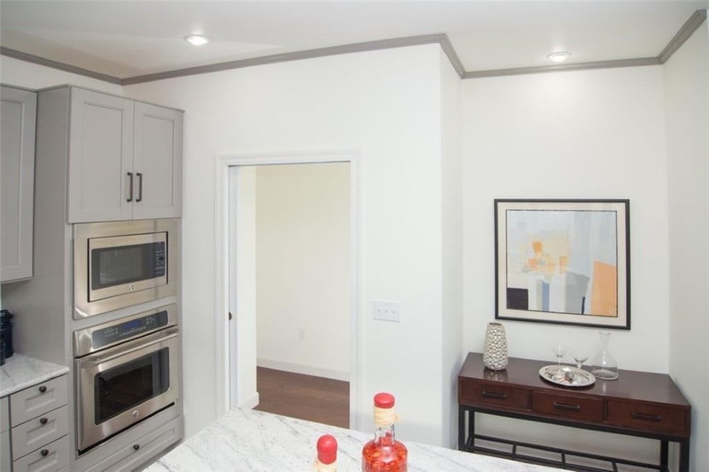 A modern kitchen interior featuring built-in appliances and stylish decor.