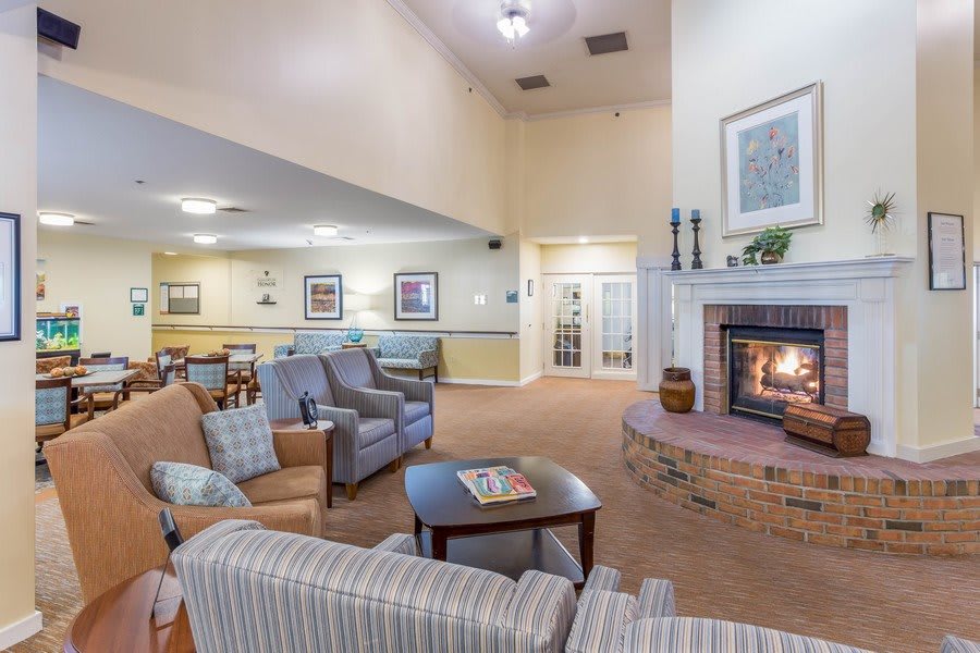 A cozy living room with comfortable seating and a warm fireplace.