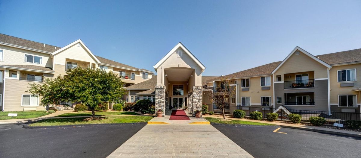 The entrance of a hotel building on a sunny day.