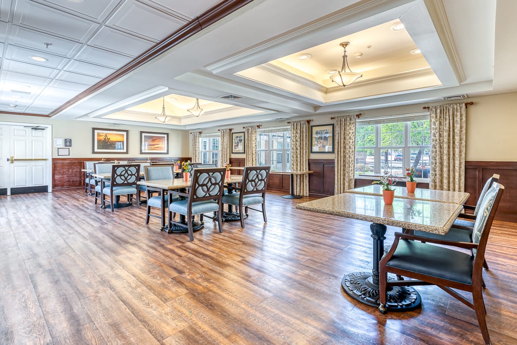 A spacious dining room with elegant furnishings and natural lighting.