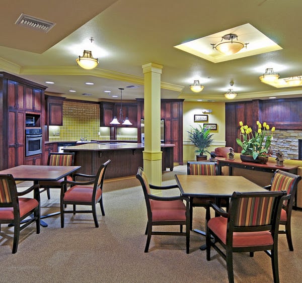 A cozy communal kitchen and dining area with warm lighting and comfortable seating.