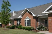 A suburban house with a brick exterior and well-maintained landscaping.