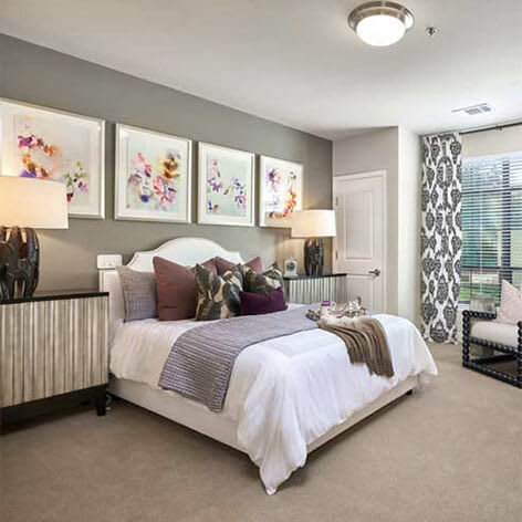 A modern bedroom with stylish decor and ample natural light.