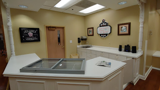 A well-lit service area featuring a counter and wall decor, suggesting a welcoming environment.