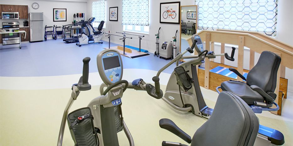 A well-equipped rehabilitation and therapy room with various exercise machines.
