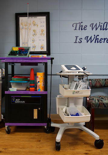 A classroom setup featuring a supply trolley and medical equipment against a motivational wall display.