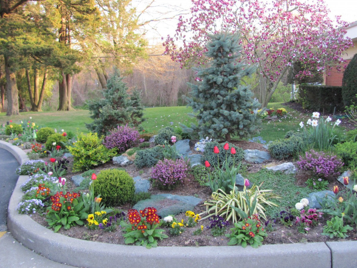A beautifully landscaped garden with colorful flowers and lush greenery.