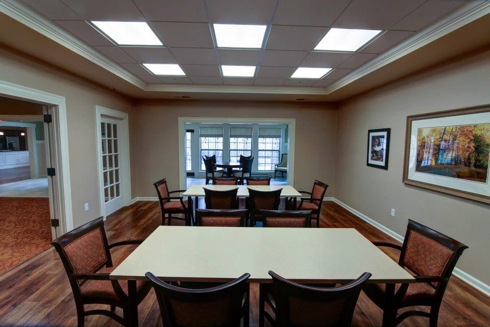 A spacious conference room with tables and chairs arranged for a meeting.