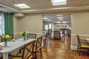 A well-lit dining area with neatly arranged tables and chairs.