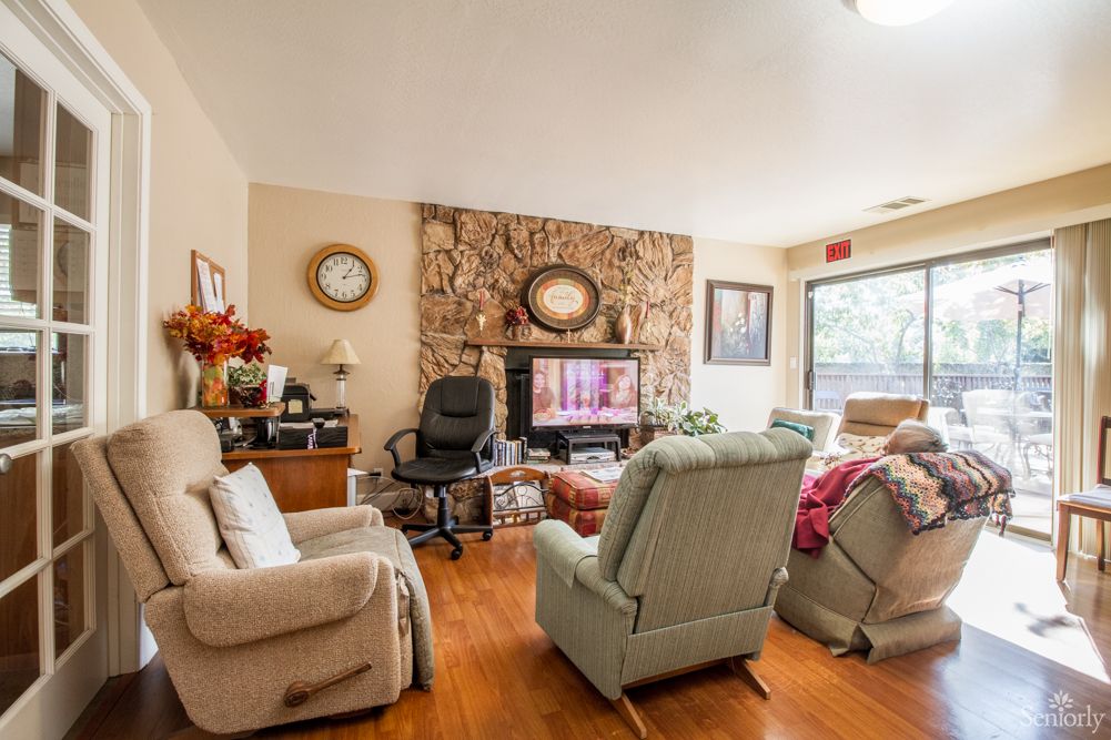 A cozy living room with recliners, a television, and decorative elements.