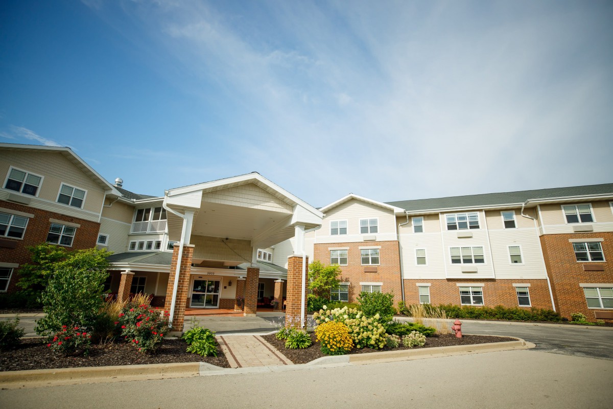 A modern residential building with a landscaped entrance.