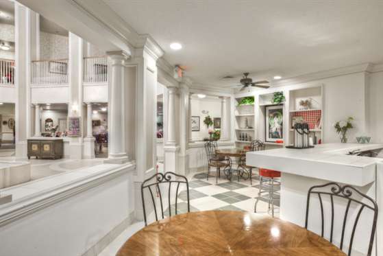 A spacious kitchen and dining area with modern decor and a checkered floor.