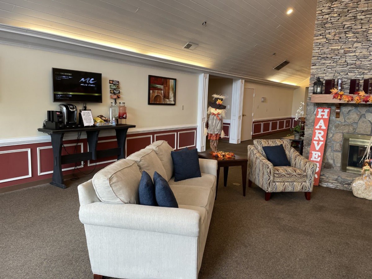 A cozy lobby area with comfortable seating and a television.