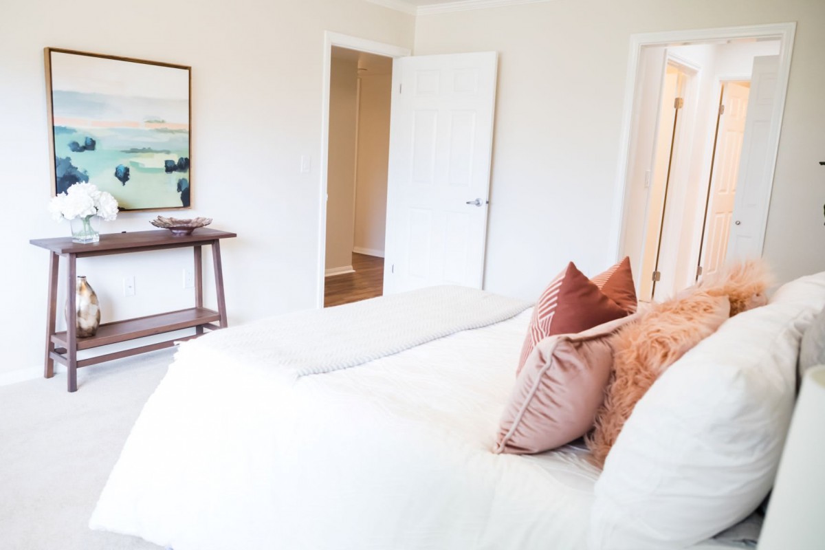 A cozy bedroom with soft pillows and a minimalist design.