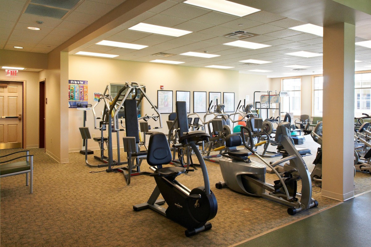 A spacious gym featuring various exercise machines and workout equipment.