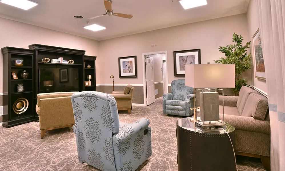 A well-decorated living room with comfortable armchairs and elegant lighting.