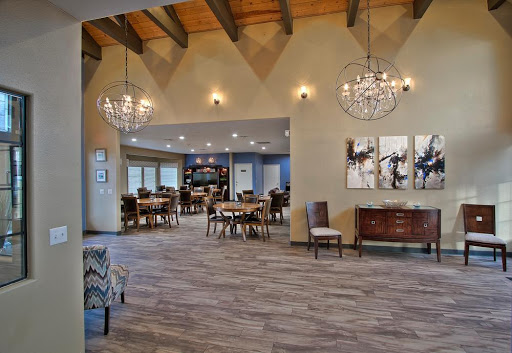 A stylish and spacious dining area with modern decor and elegant chandeliers.