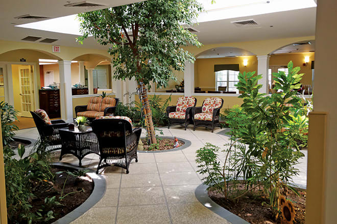 A tranquil indoor garden with comfortable seating and abundant natural light.