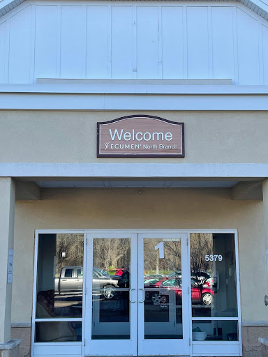 Entrance of a building with a welcoming sign.