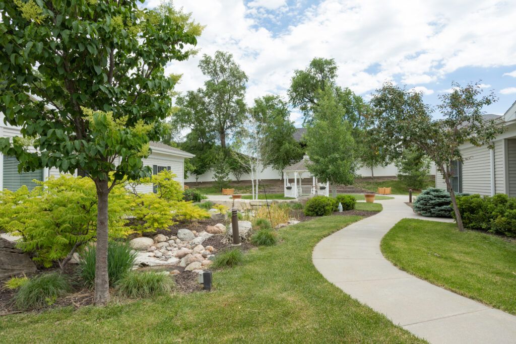 A serene garden featuring a winding pathway, lush greenery, and a charming gazebo.