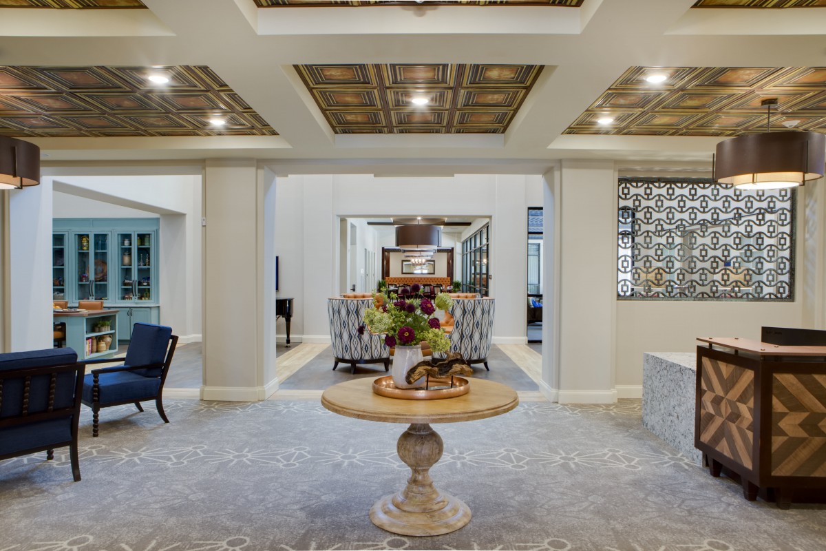 A luxurious entryway featuring elegant furniture and intricate ceiling designs.