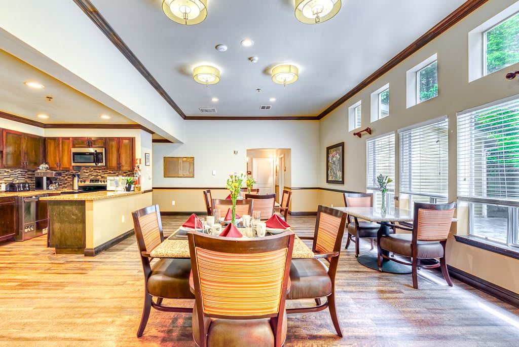 A well-lit dining room with elegant furniture and decor.