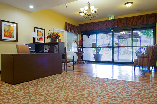 A spacious lobby area with a reception desk and decorative lighting.